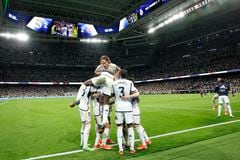 Real Madrid players celebrate their third goal scored by Real Madrid's English midfielder #5 Jude Bellingham during the Spanish league football match between Real Madrid CF and FC Barcelona at the Santiago Bernabeu stadium in Madrid on April 21, 2024. (Photo by OSCAR DEL POZO / AFP)