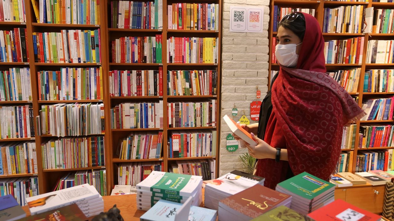 Una mujer escogiendo libros en una librería de la calle Enqelab (Revolución) en Teherán. Foto: Atta Kenare / AFP