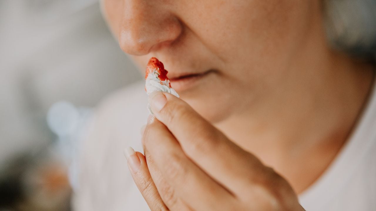 Woman wiping her bleeding nose with tissue