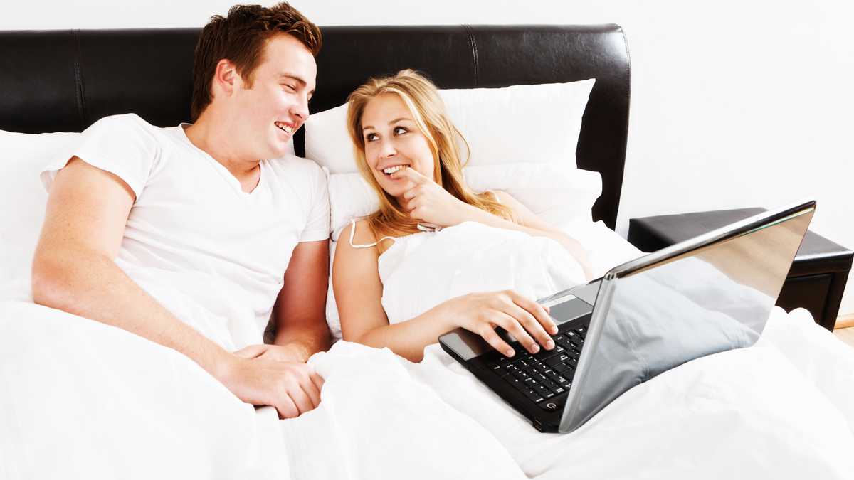 Couple in bed with laptop