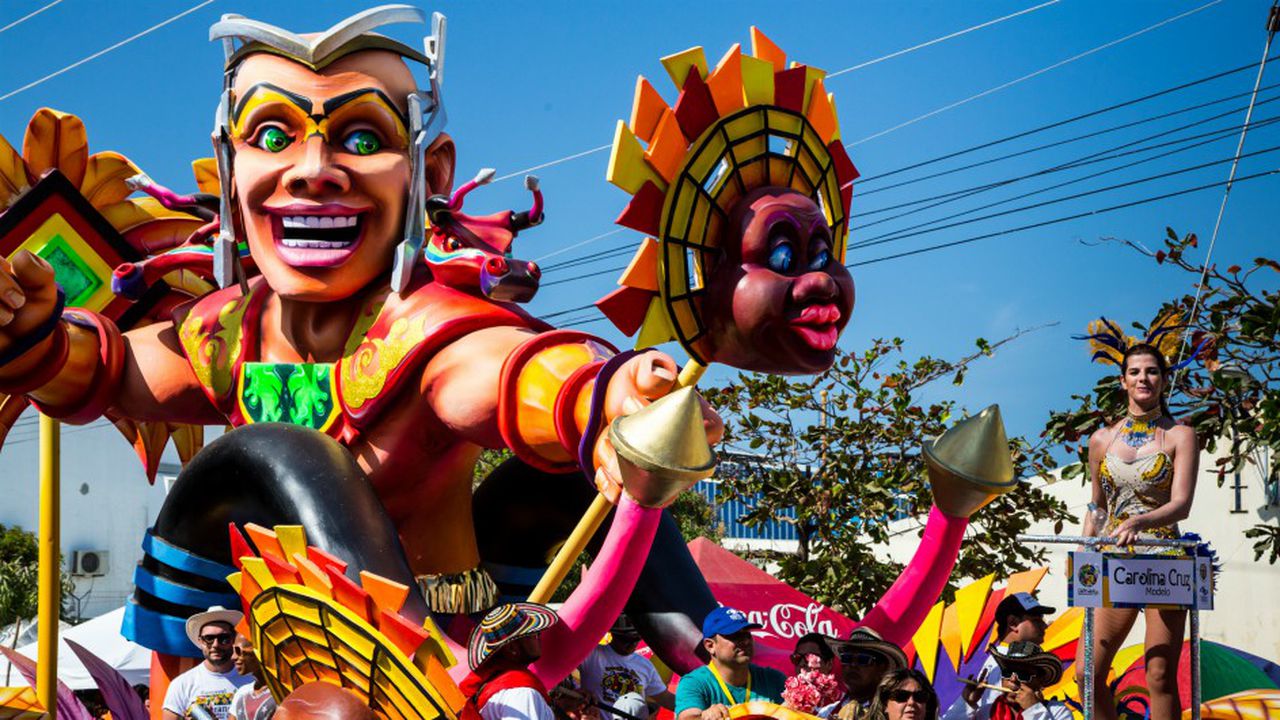 Coloridas carrozas llenas de cantantes, bailarines y modelos recorren la calle durante la Battalla de Flores. Desfile de la cumbre del Carnaval de Barranquilla.