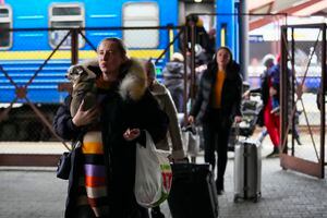 People fleeing the conflict from neighboring Ukraine arrive to Przemysl train station in Przemysl, Poland, on Friday, Feb. 25, 2022. (AP Photo/Petr David Josek)
