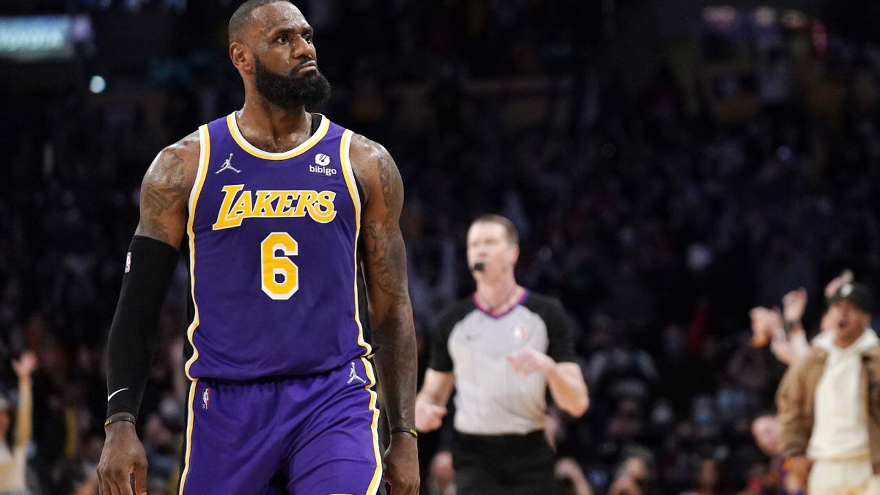 Los Angeles Lakers forward LeBron James reacts toward Aaron Donald of the Los Angeles Rams, who was sitting court side, after scoring during the second half of an NBA basketball game against the Utah Jazz Wednesday, Feb. 16, 2022, in Los Angeles. The Lakers won 106-101. (AP/Mark J. Terrill)