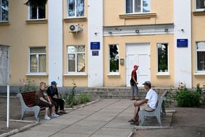 Pensioners wait outside Oschadbank to receive pension money in Siversk, in Donetsk Oblast, eastern Ukraine, on July 8, 2022, amid the Russian invasion of Ukraine. (Photo by MIGUEL MEDINA / AFP)