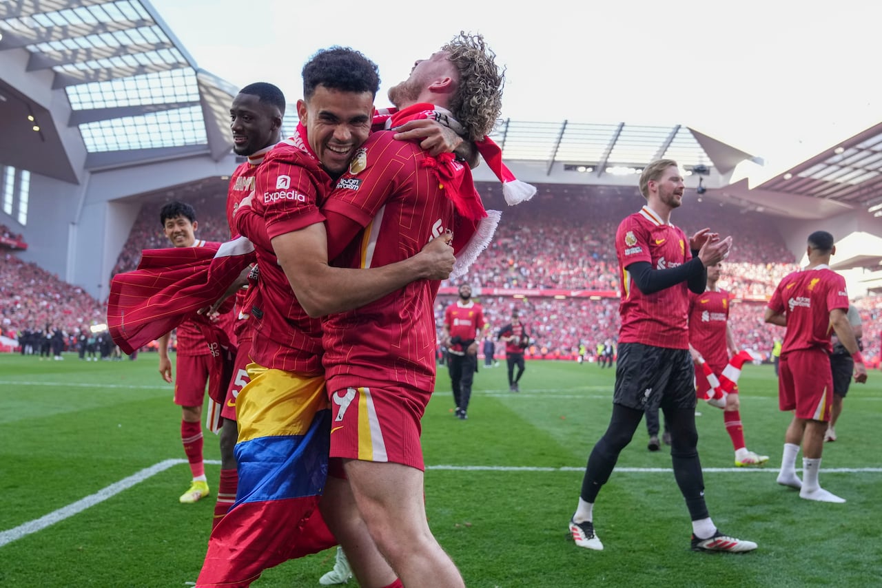 Liverpool's Luis Diaz, left, and Harvey Elliott celebrate after winning the English Premier League soccer match between Liverpool and Tottenham Hotspur and clinching the Premier League title at Anfield in Liverpool, England, Sunday, April 27, 2025. (AP Photo/Jon Super)