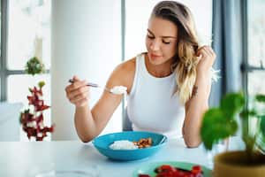 Young woman eating lunch alone at the restaurant.