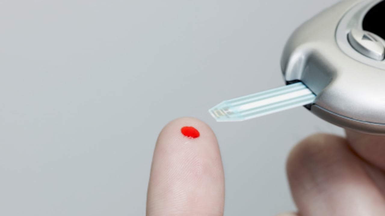 Man using a Glucose Reader.