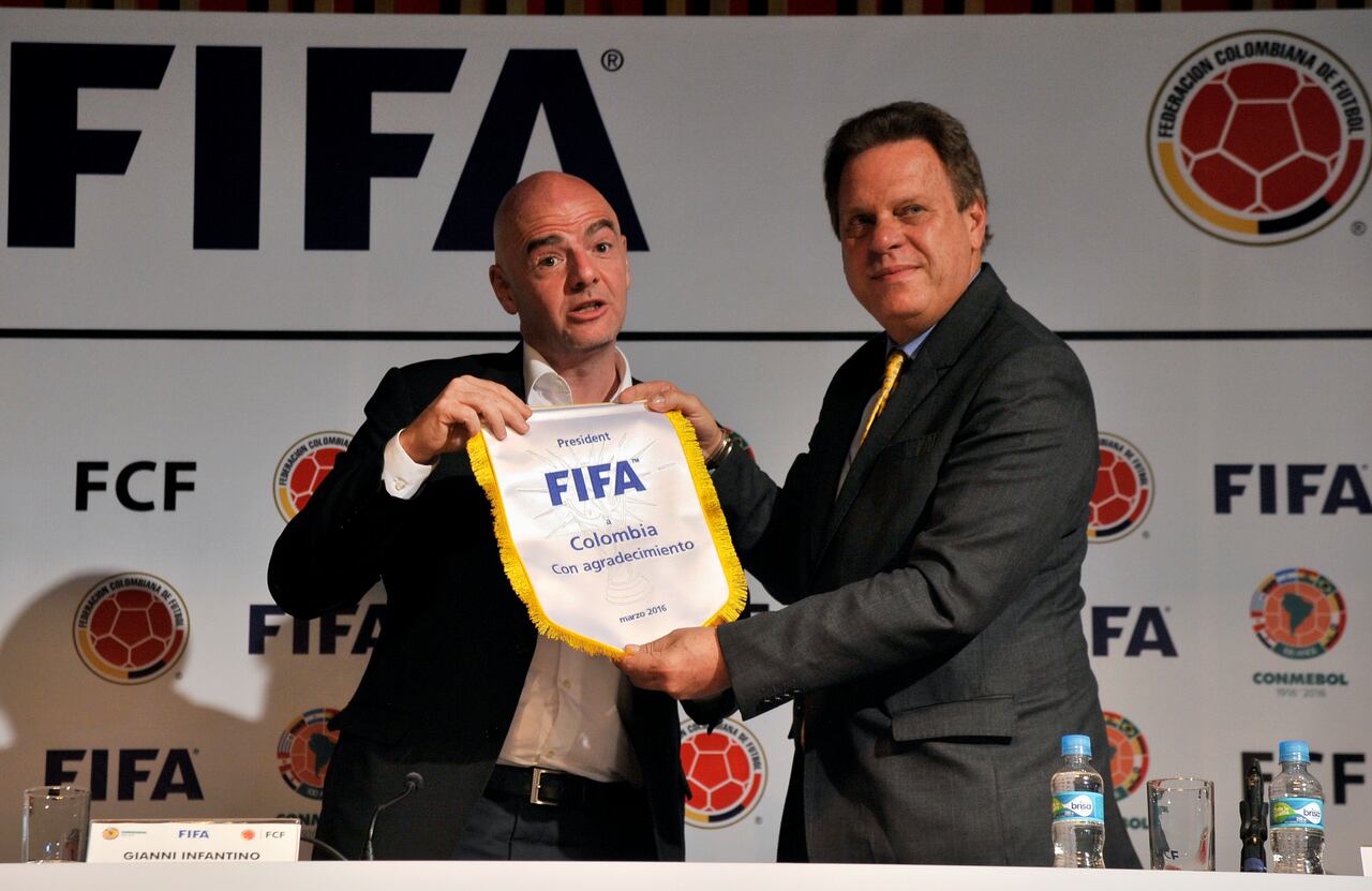 BOGOTA, COLOMBIA - MARCH 31: FIFA President Gianni Infantino (L) gives a present to Colombian Futbol Federation President Ramon Jesurum (R) during a press conference as part of FIFA President Gianni Infantino's visit to South America on March 31, 2016 in Bogota, Colombia. (Photo by Gal Schweizer/LatinContent via Getty Images)