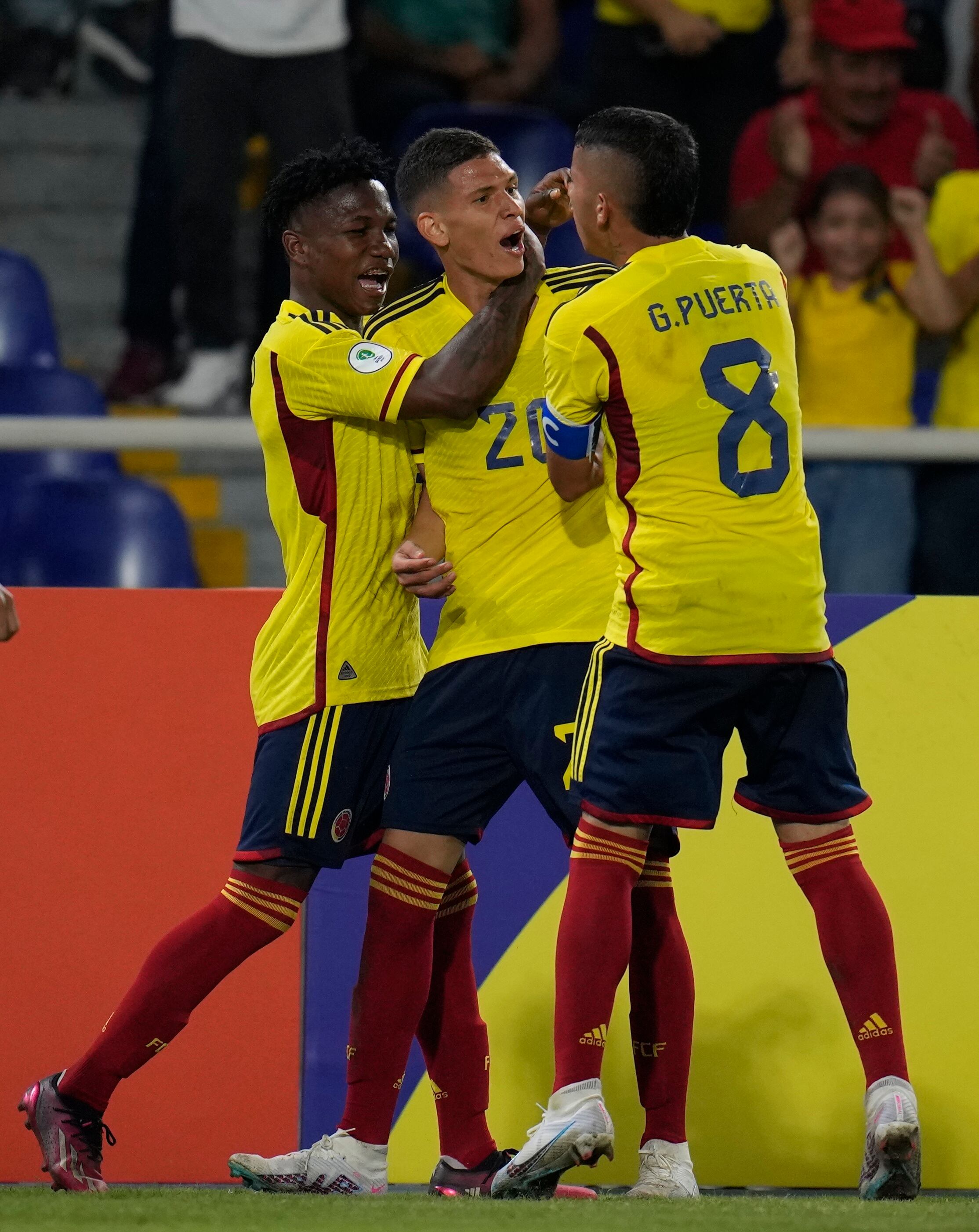 Colombia's Daniel Luna, center, celebrates with his teammates after scoring his side's first goal during a South America U-20 Championship soccer match against Paraguay, in Cali, Colombia, Thursday, Jan. 19, 2023. (AP Photo/Fernando Vergara)