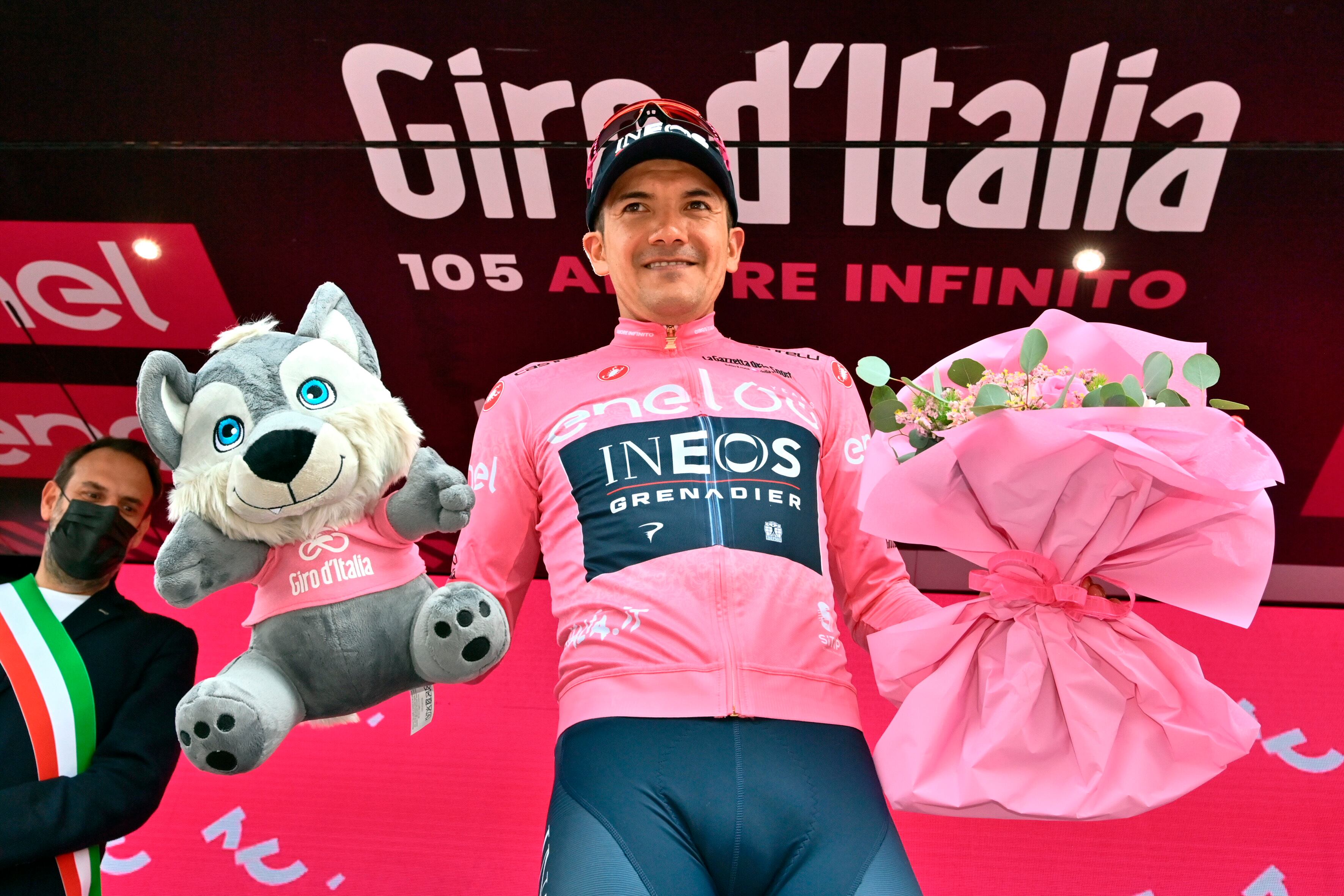 Ecuador's Richard Carapaz wears the pink jersey of the overall leader as he celebrates on podium after completing the 18th stage of the Giro D'Italia cycling race, from Borgo Valsugana to Treviso, Italy, Thursday, May 26, 2022. (Massimo Paolone/LaPresse via AP)