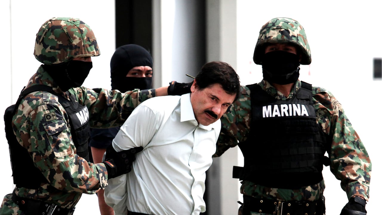 Mexican Navy soldiers escort Joaquin Guzman Loera (front), alias "El Chapo Guzman", leader of the Sinaloa Cartel, during his show up in front of the press, at the Mexican Navy hangar in Mexico City, capital of Mexico, on Feb. 22, 2014. Mexican President Enrique Pena Nieto on Saturday confirmed the capture of the world's most wanted drug lord, Joaquin Guzman Loera, known as El Chapo, in the Pacific resort of Mazatlan. (Photo by Jair Cabrera Torres/NurPhoto) (Photo by NurPhoto/Corbis via Getty Images)