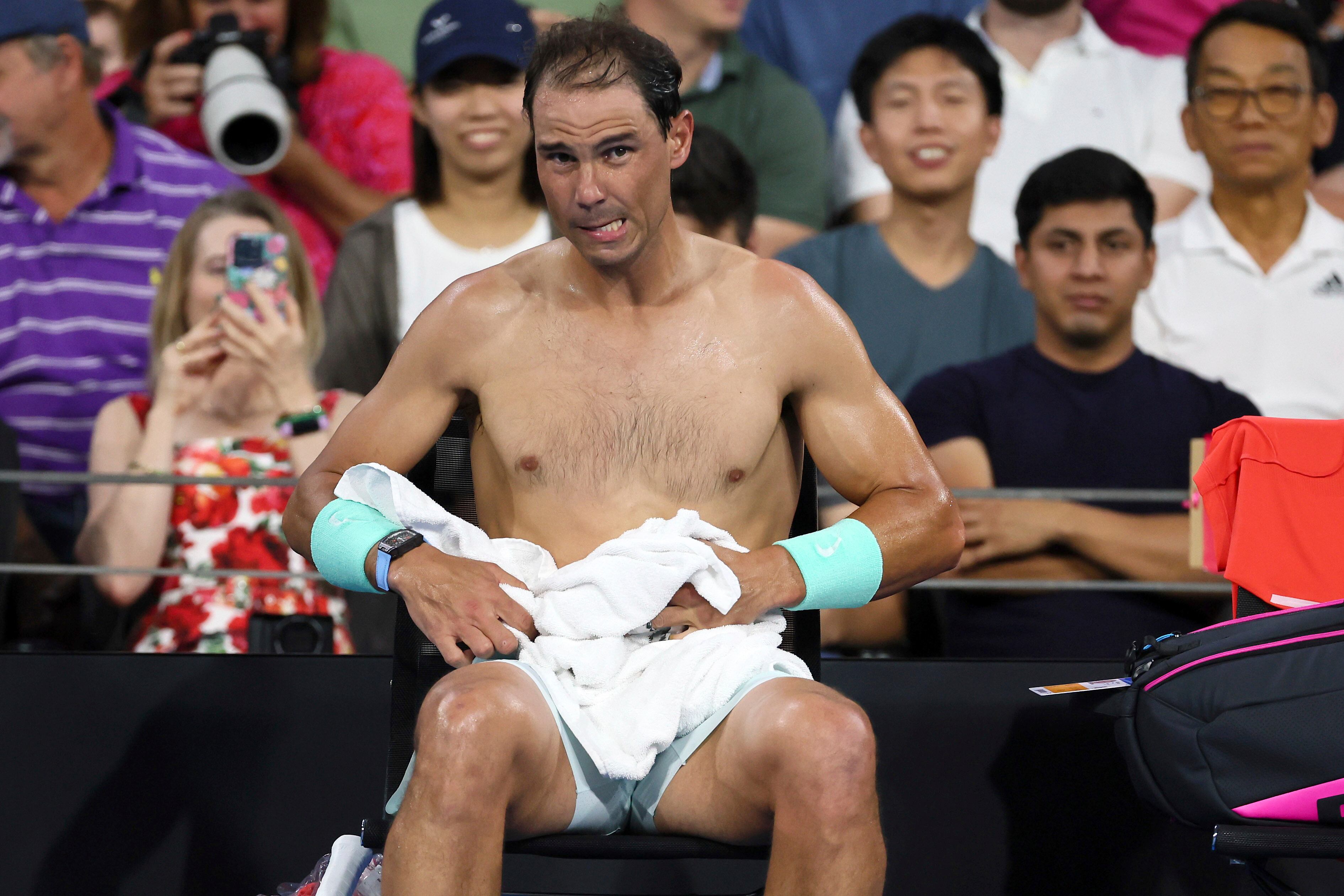 Rafael Nadal of Spain changes his shirt in his match against Dominic Thiem of Austria during the Brisbane International tennis tournament in Brisbane, Australia, Tuesday, Jan. 2, 2024. (AP Photo/Tertius Pickard)