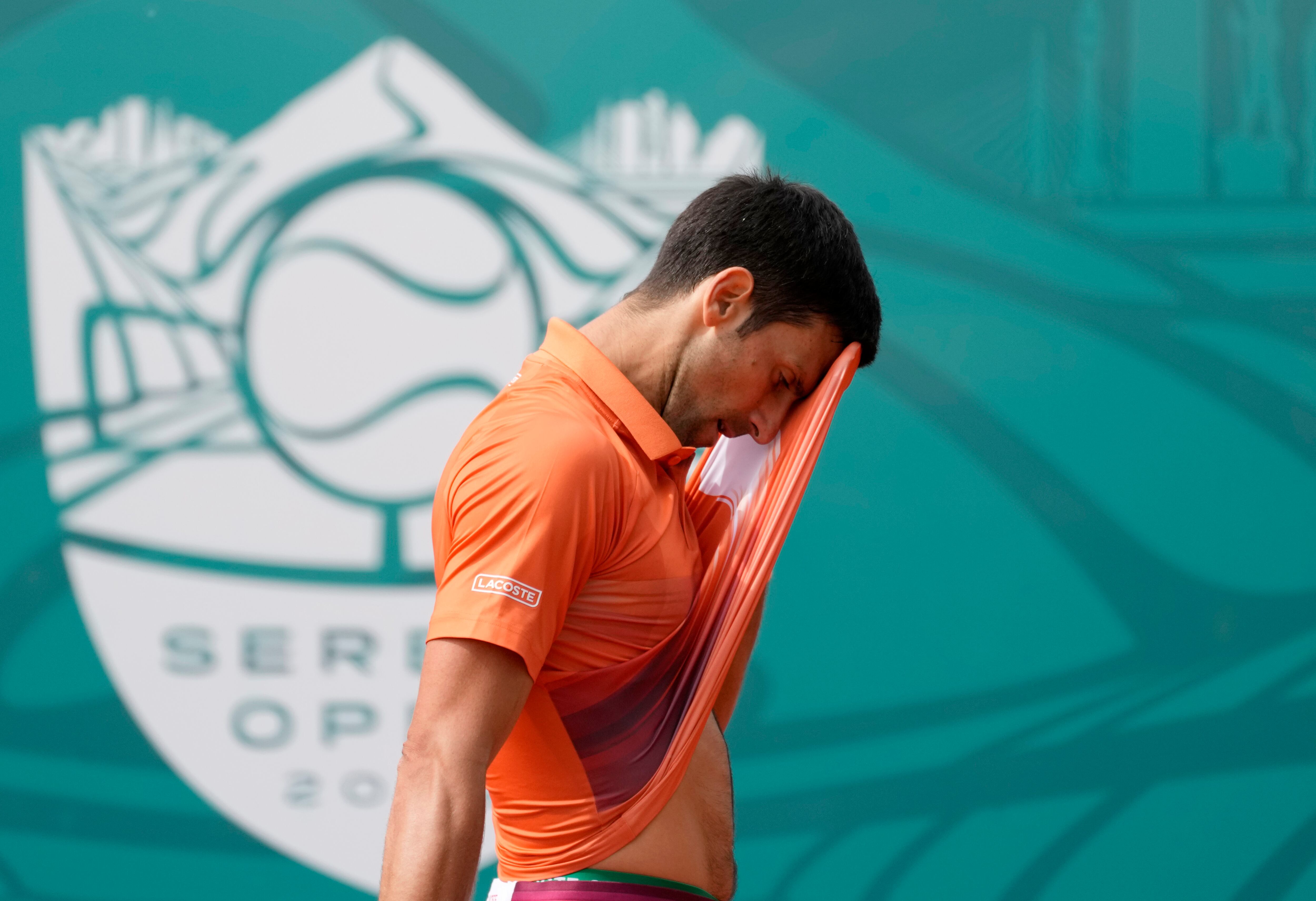 Novak Djokovic of Serbia wipes his face during their final tennis match of the Serbia Open tennis tournament against Andrey Rublev of Russia, in Belgrade, Serbia, Sunday, April 24, 2022. (AP Photo/Darko Vojinovic)