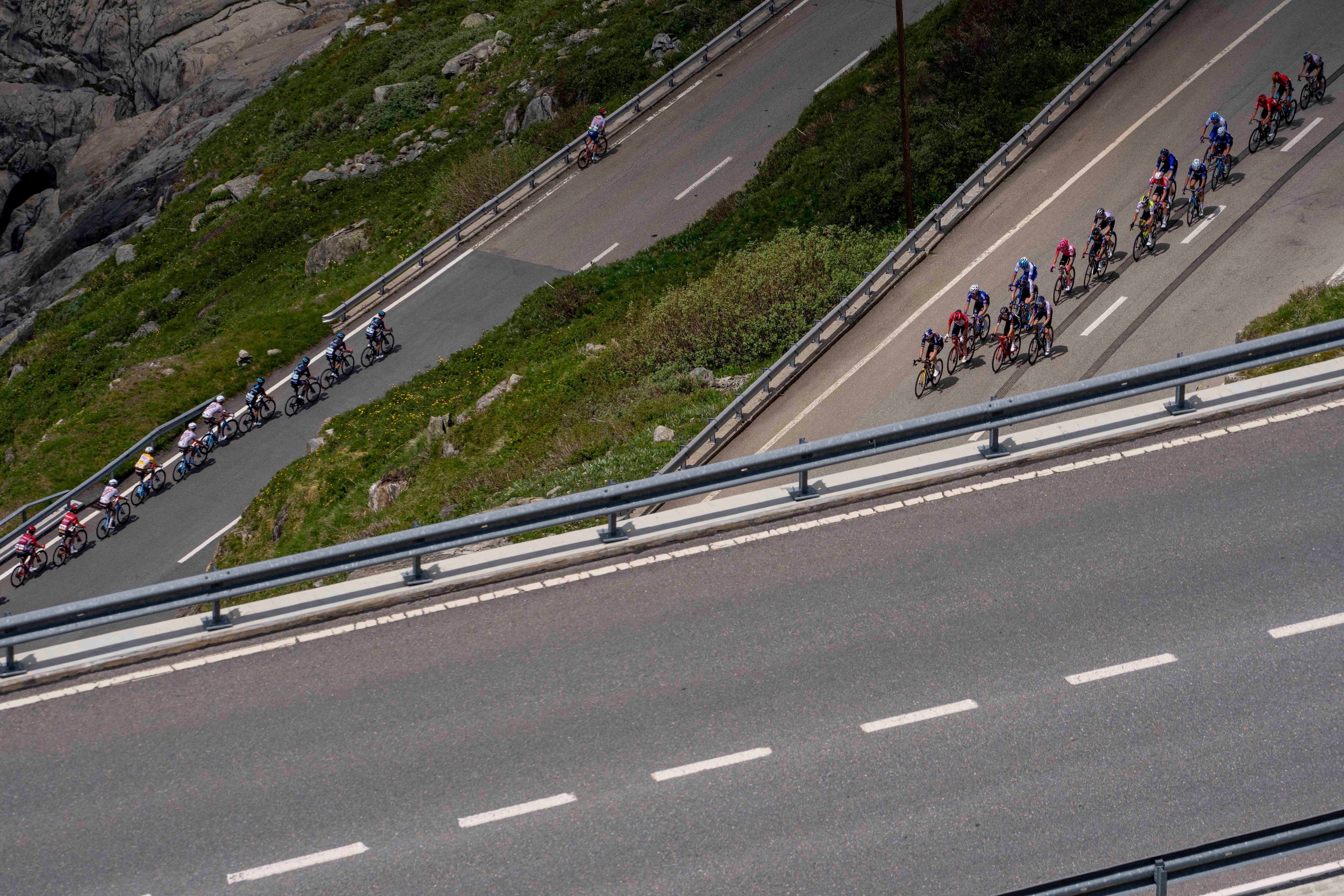 The pack climbs the Furka pass during the fifth stage, a 211 km race from Fiesch to La Punt, of the 86th Tour de Suisse UCI World Tour cycling race in Goms, Switzerland, Thursday, June 15, 2023. (AP Photo/Matthias Schrader)