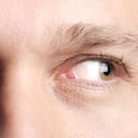 close up of a man's eyes looking off