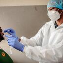 A nurse from Lancet Nectare hospital (R) performs a COVID-19 coronavirus test in Richmond, Johannesburg, on December 18, 2020. (Photo by LUCA SOLA / AFP)