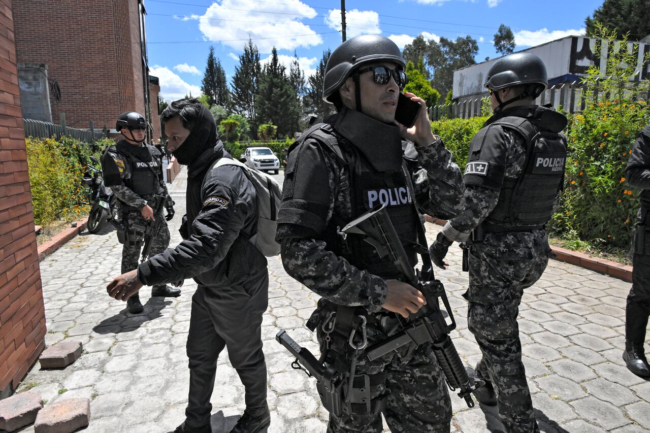 Police officers stand guard at the Vertical Cemetery before the funeral of slain Ecuadorean presidential candidate Fernando Villavicencio, a day after his assassination, in Quito, on August 10, 2023. Villavicencio, the second most popular candidate in the presidential race according to recent opinion polls, was shot dead while leaving a rally in the nation's capital on Wednesday, prompting President Guillermo Lasso to declare a state of emergency and blame the assassination on organized crime. Villavicencio, a 59-year-old anti-corruption crusader who had complained of receiving threats, was murdered as he was leaving a stadium in Quito after holding a campaign rally, officials said.