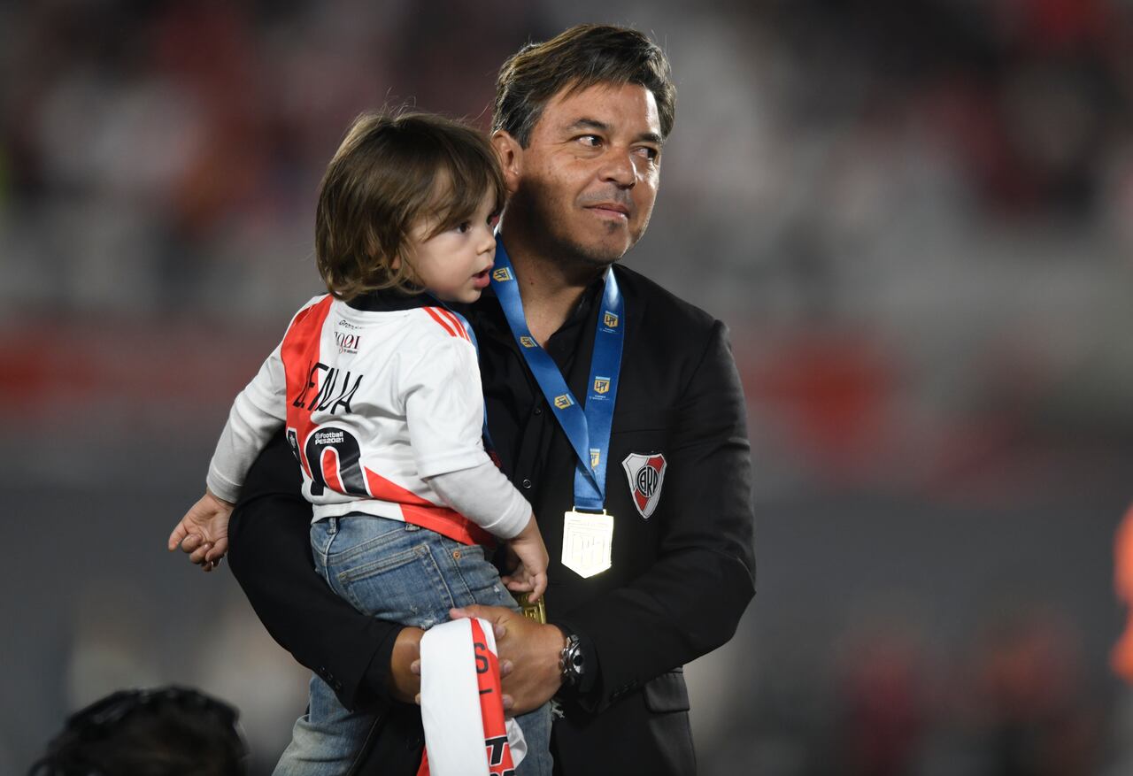 River Plate coach Marcelo Gallardo holds his sone Benjamin as he celebrates winning the local soccer tournament at the Monumental in Buenos Aires, Argentina Thursday, Nov. 25, 2021. River defeated Racing 4-0 and became the tournament champions. (AP Photo/Gustavo Garello)