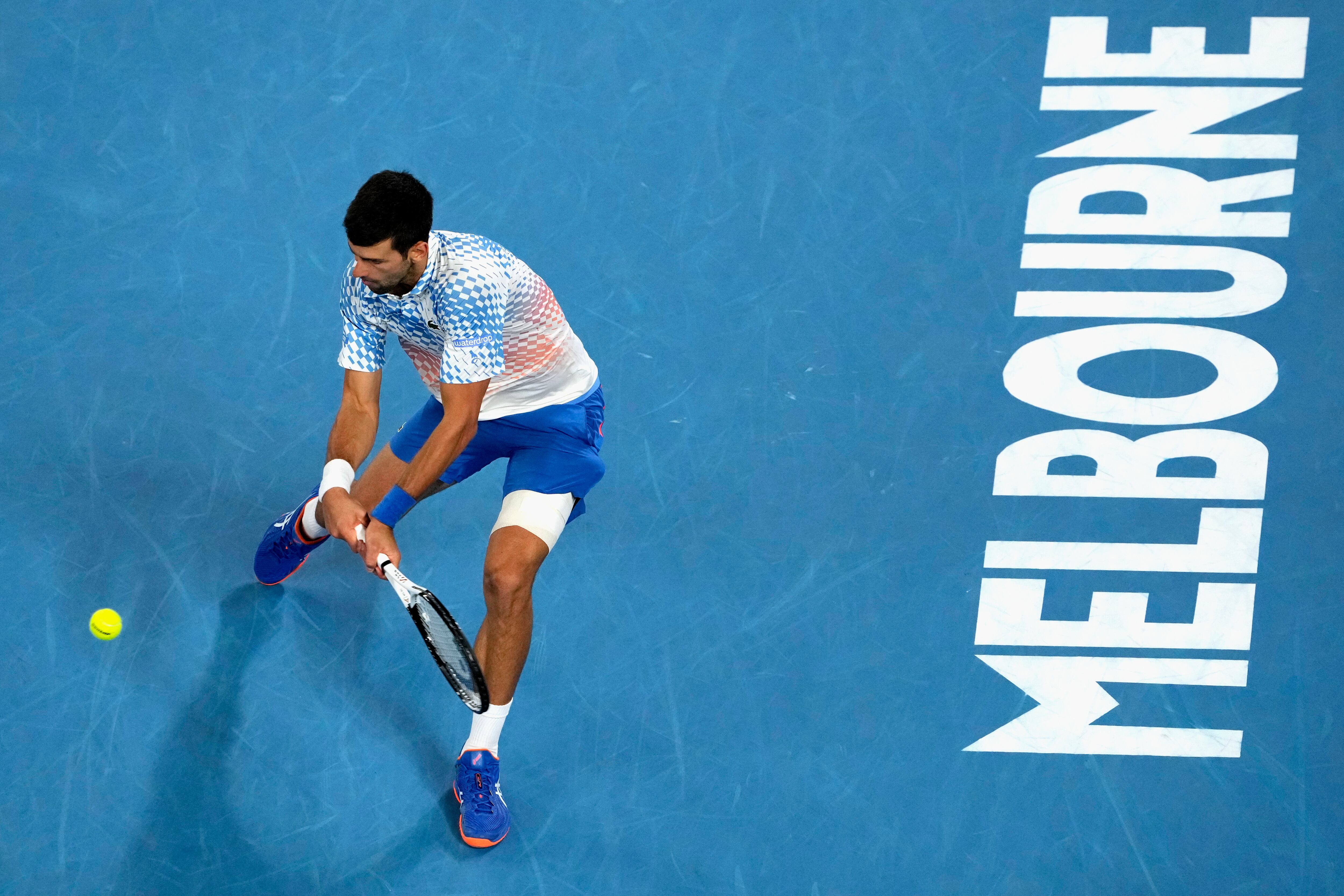 Novak Djokovic of Serbia plays a backhand return to Andrey Rublev of Russia during their quarterfinal match at the Australian Open tennis championship in Melbourne, Australia, Wednesday, Jan. 25, 2023. (AP Photo/Aaron Favila)
