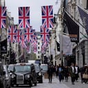 Union flags are raised to celebrate the upcoming coronation of King Charles III, in central London, Wednesday, April 26, 2023. (AP Photo/Kin Cheung)