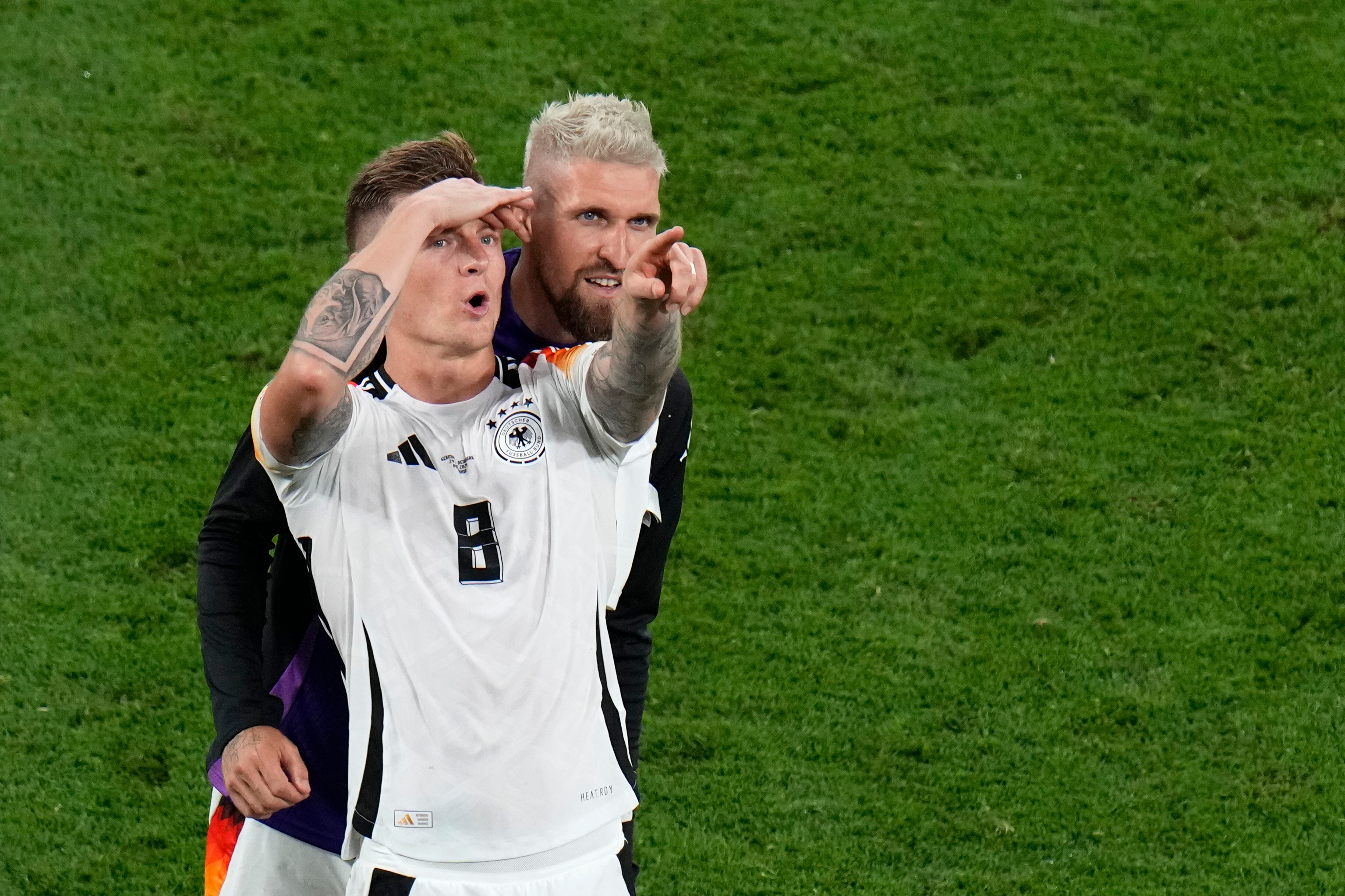 Germany's Toni Kroos, left, and Germany's Robert Andrich gesture at the end of the round of sixteen match between Germany and Denmark at the Euro 2024 soccer tournament in Dortmund, Germany, Saturday, June 29, 2024. (AP Photo/Hassan Ammar)