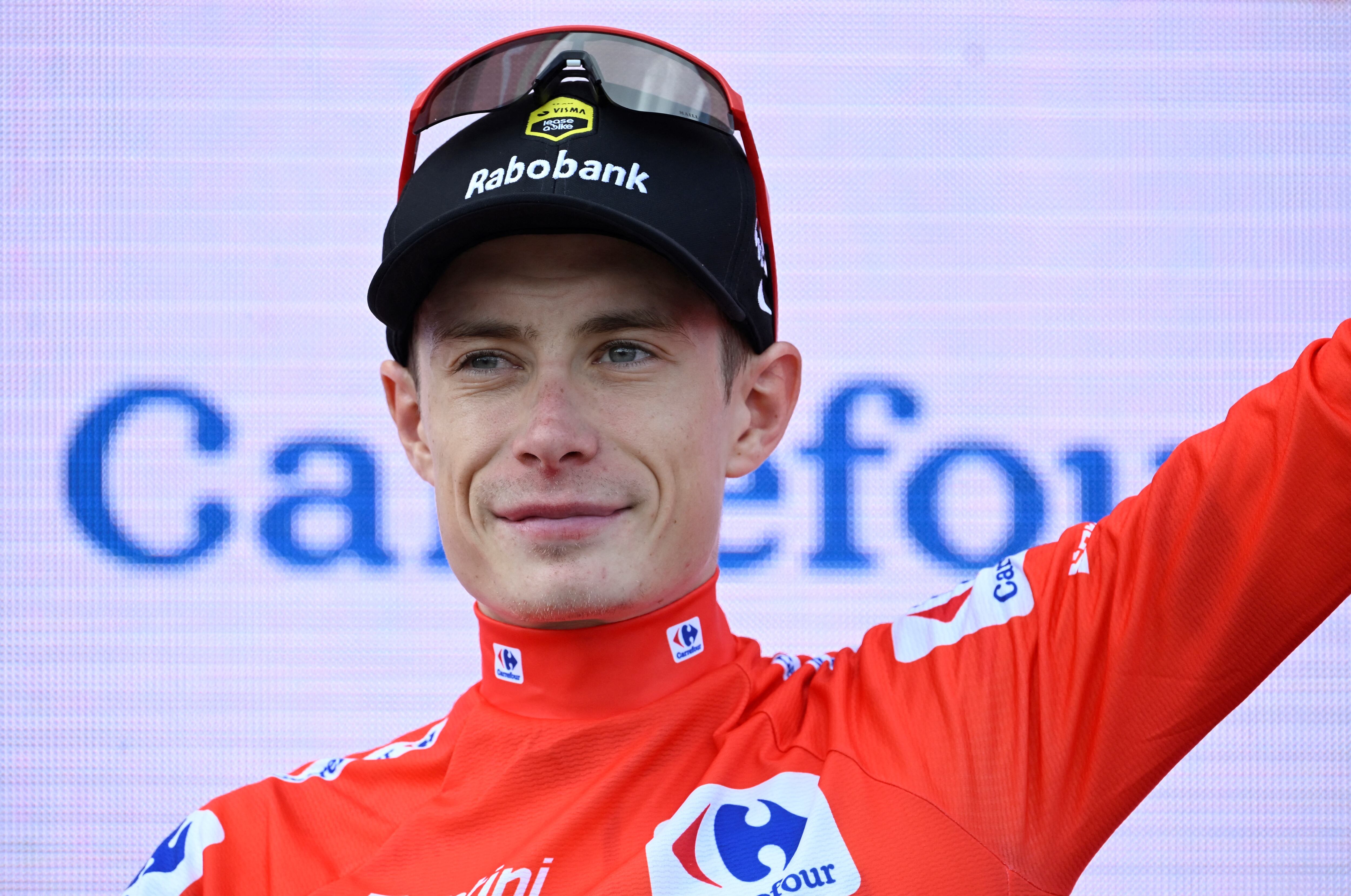 Overall leader of the Team Visma-Lease a Bike, Danish rider Jonas Vingegaard wearing the red jersey celebrates on the podium after the 15th stage of the Vuelta a Espana cycling tour, a 167 km race between A Veiga/Vegaredo and Monforte de Lemos, on September 7, 2025. (Photo by Miguel RIOPA / AFP)