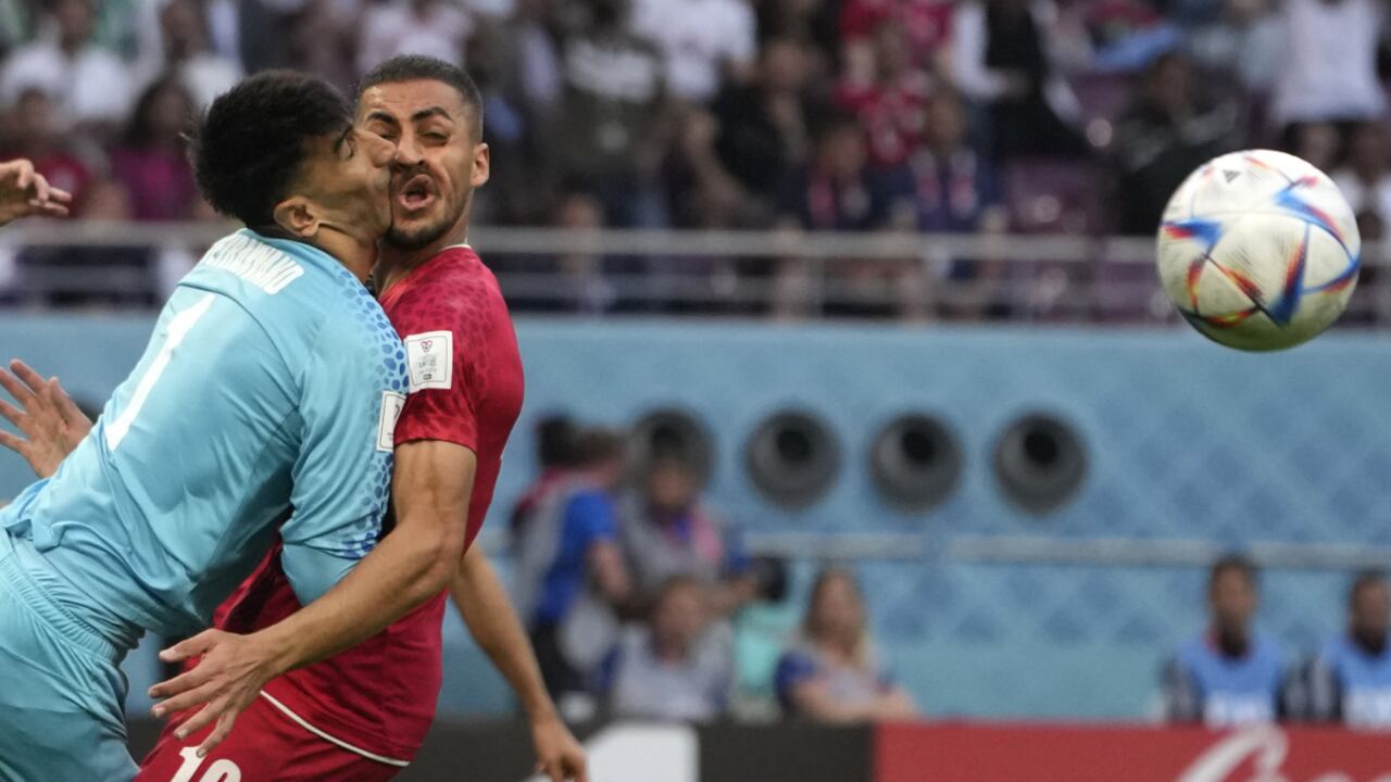 Iran's goalkeeper Alireza Beiranvand collides with Iran's Majid Hosseini, right, during the World Cup group B soccer match between England and Iran at the Khalifa International Stadium in Doha, Qatar, Monday, Nov. 21, 2022. (AP/Alessandra Tarantino)