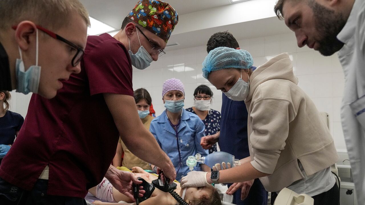 Medics perform CPR on a girl injured during the shelling of a residential area, in the city hospital of Mariupol, eastern Ukraine, Sunday, Feb. 27, 2022. The girl did not survive. (AP Photo/Evgeniy Maloletka)