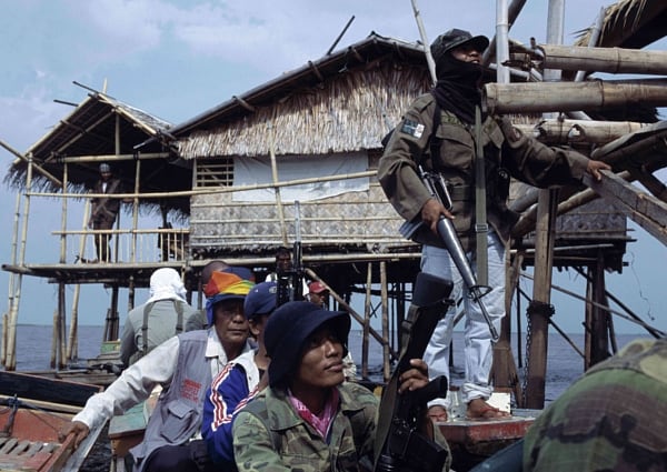 Filipinas: Una bufanda colorida en la cabeza identifica a un inspector de los guardias de cese de fuego – civiles que están documentando ataques a personas y edificios, sin importar si estos pasan en zonas controladas por las fuerzas armadas o como aquí en Liguasan March, la zona de descanso de los rebeldes.

