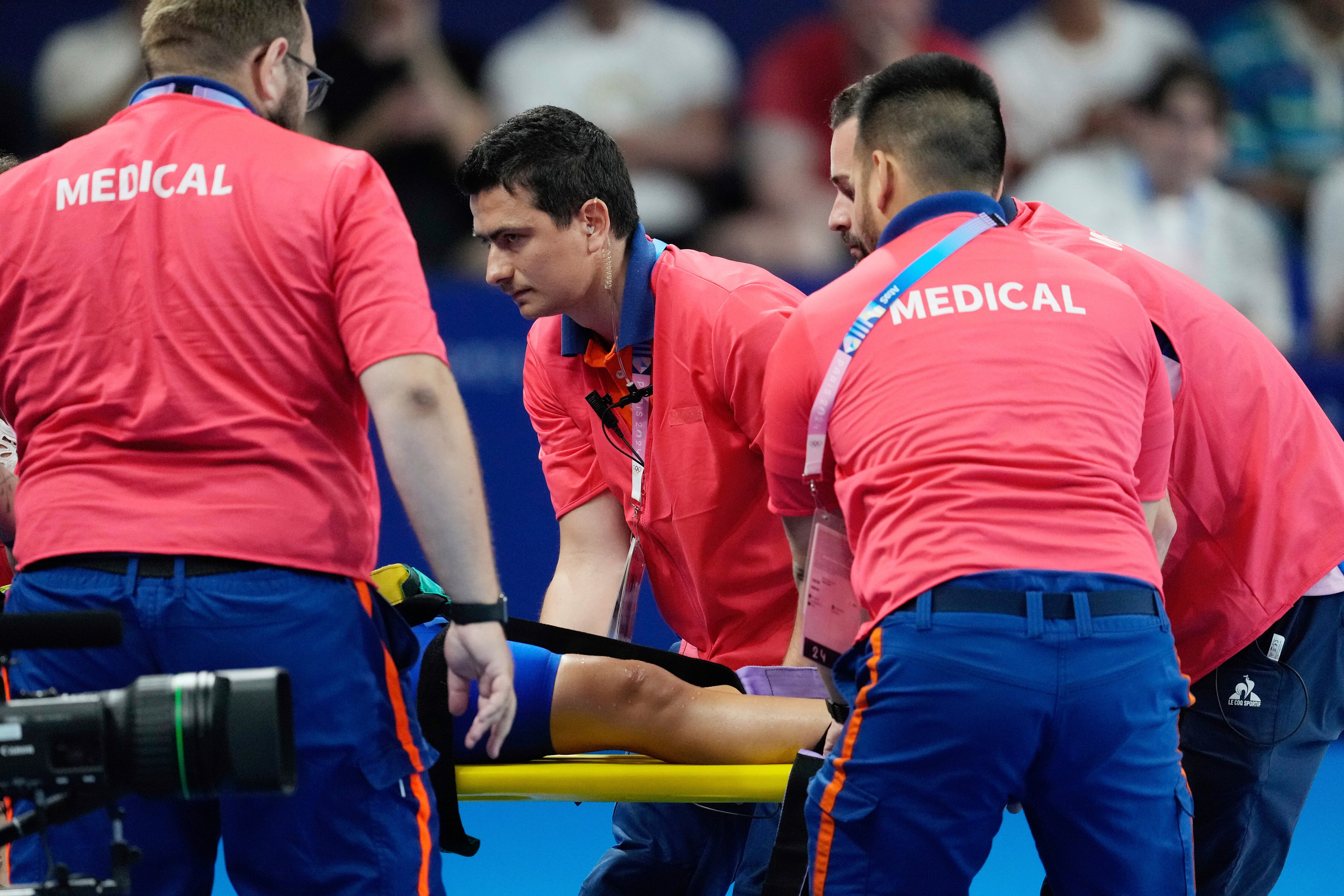 Members of the medical team carry Slovakia's Tamara Potocka during a women's 200-meter individual medley heat at the Summer Olympics in Nanterre, France, Friday, Aug. 2, 2024. (AP Photo/Ashley Landis)
