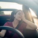 Tired woman driving car