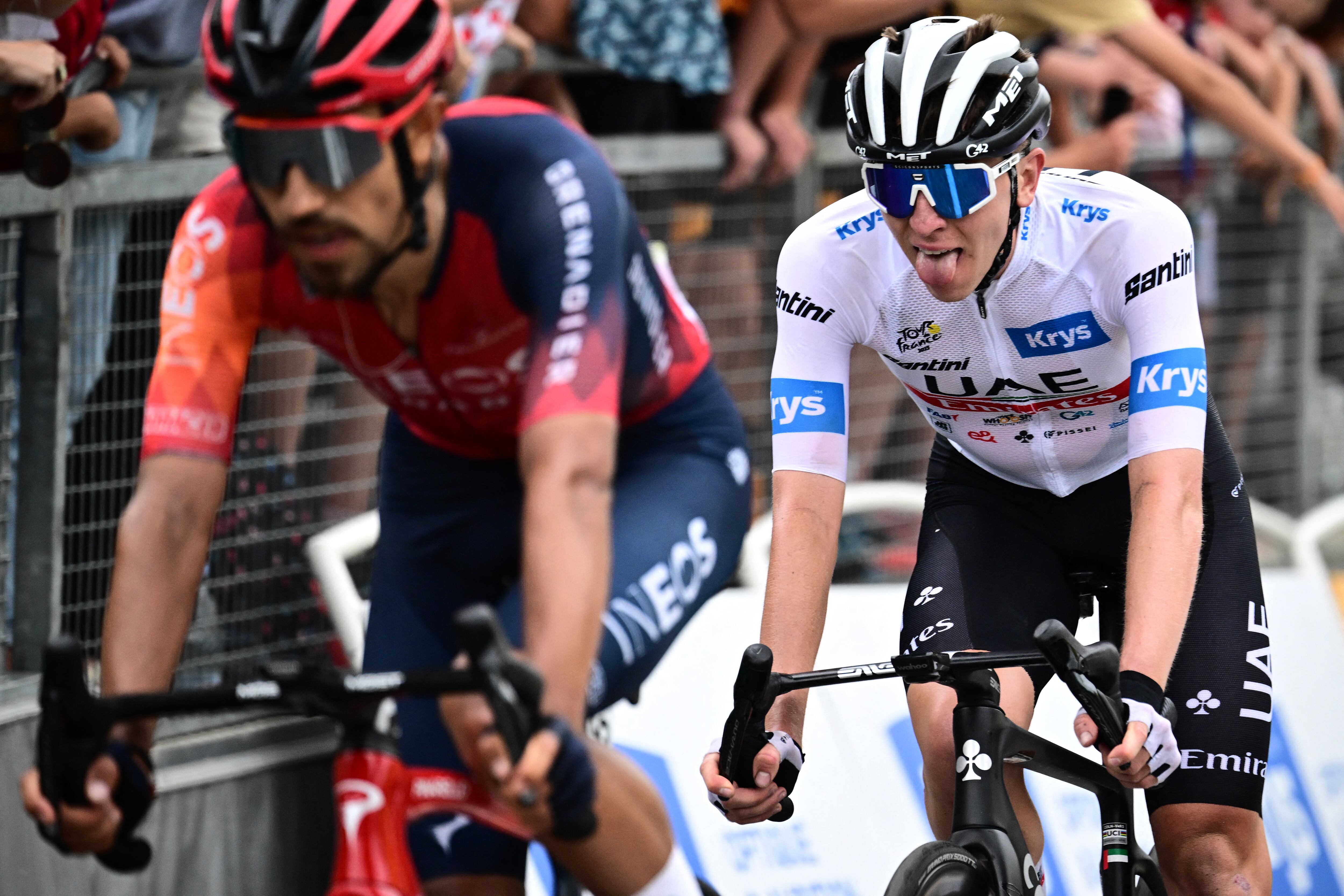 UAE Team Emirates' Slovenian rider Tadej Pogacar wearing the best young rider's white jersey (R) cycles to the finish line of the 5th stage of the 110th edition of the Tour de France cycling race, 163 km between Pau and Laruns, in the Pyrenees mountains in southwestern France, on July 5, 2023. (Photo by Marco BERTORELLO / AFP)