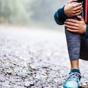 Foto de referencia de mujer haciendo ejercicio y con dolor en su rodilla.