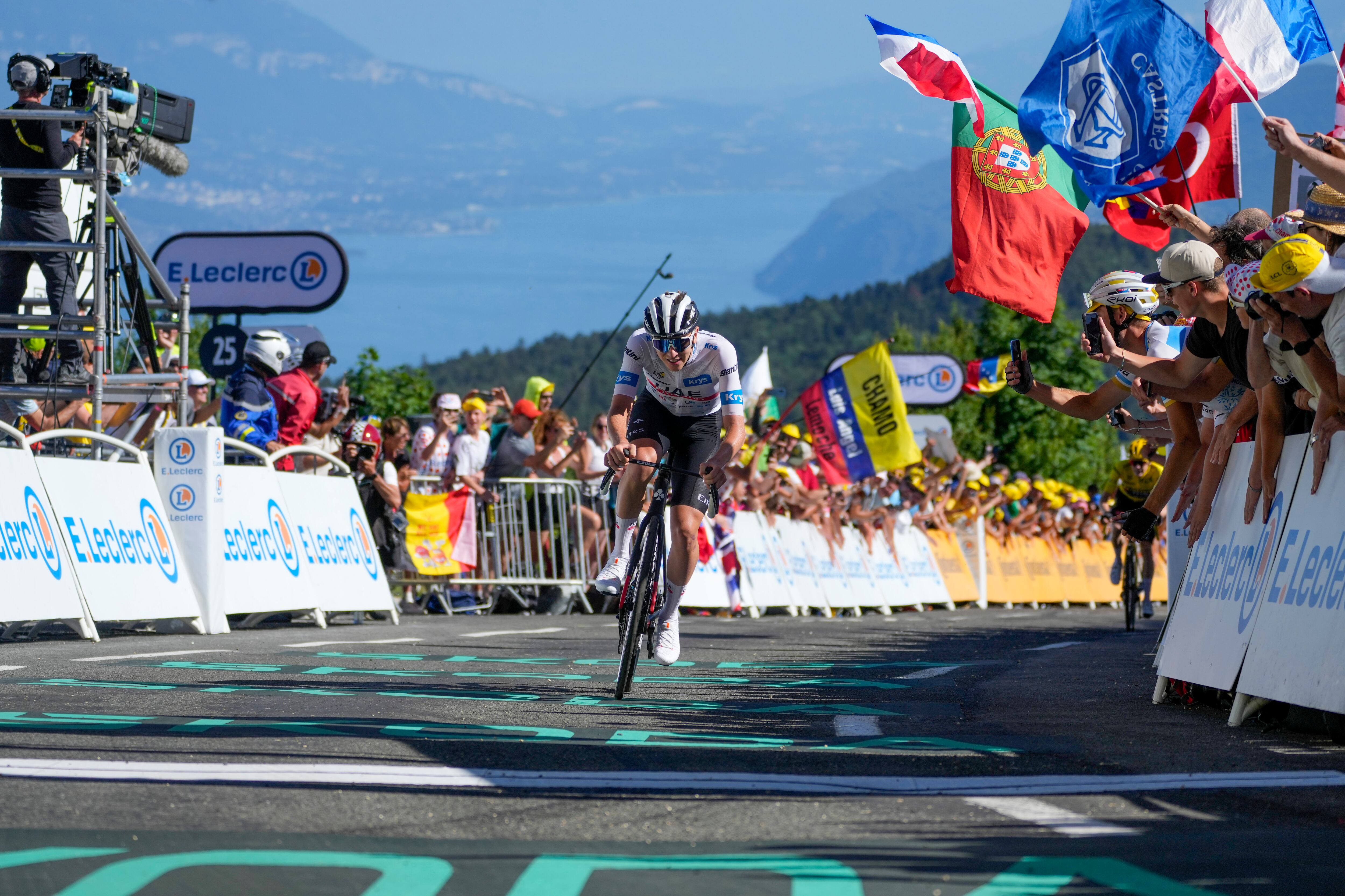Slovenia's Tadej Pogacar, wearing the best young rider's white jersey, crosses the finish line during the thirteenth stage of the Tour de France cycling race over 138 kilometers (86 miles) with start in Chatillon-sur-Chalaronne and finish on Grand Colombier pass, France, Friday, July 14, 2023. (AP Photo/Thibault Camus)