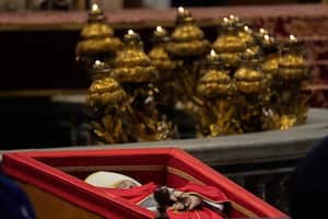 The body of Pope Francis is carried into St. Peter's Basilica at the Vatican, Wednesday, April 23, 2025, where he will lie in state for three days. (AP Photo/Emilio Morenatti)