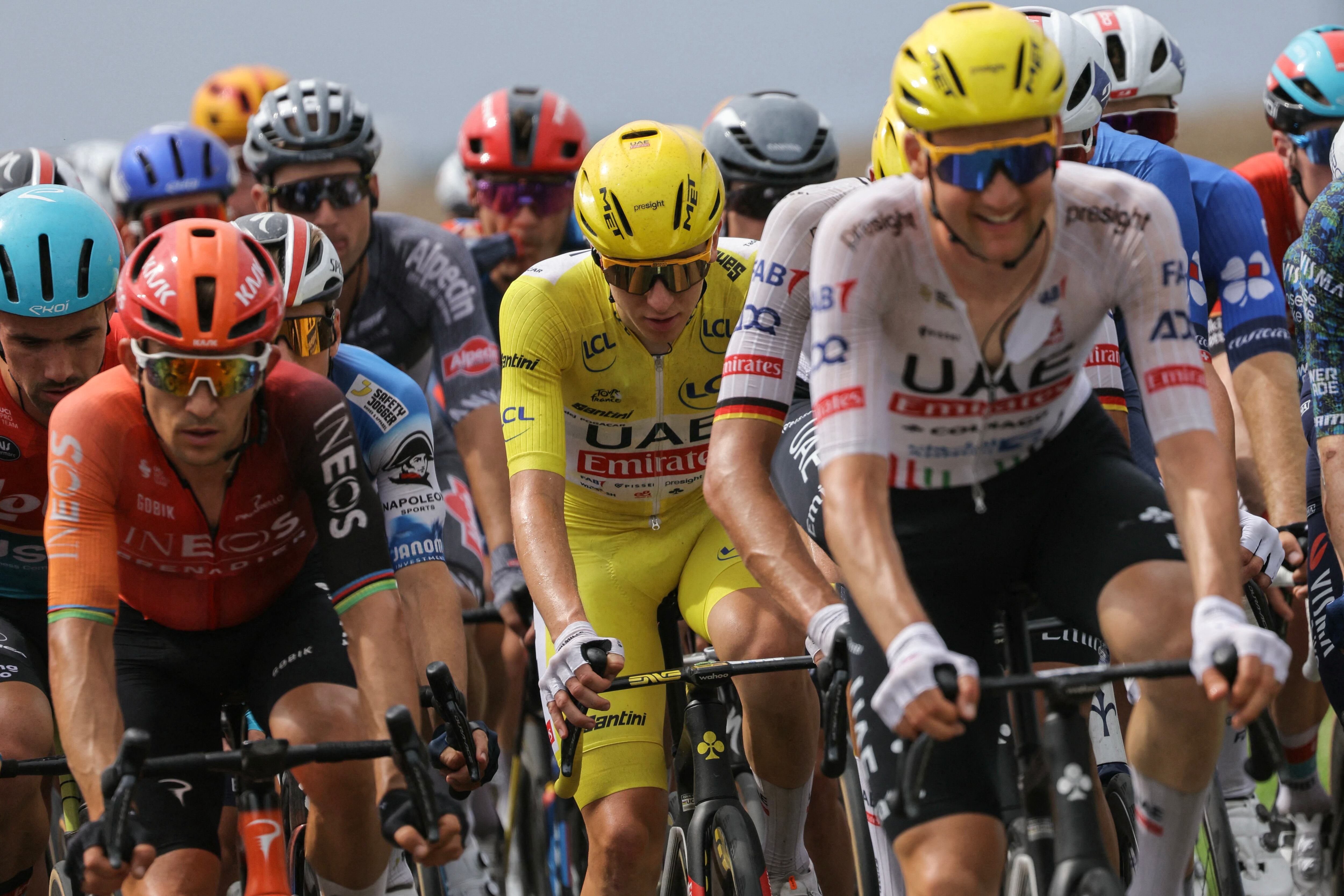 UAE Team Emirates team's Slovenian rider Tadej Pogacar wearing the overall leader's yellow jersey cycles with the pack of riders (peloton) during the 10th stage of the 111th edition of the Tour de France cycling race, 187,3 km between Orleans and Saint-Amand-Montrond, central France, on July 9, 2024. (Photo by Thomas SAMSON / AFP)
