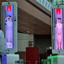 A passenger crosses a newly deployed fast-track gate that uses face and iris-recognition technologies at Dubai international airport, on March 7, 2021. - The new biometric system has been deployed at 122 smart gates at arrival and departure terminals for first class passengers. (Photo by Mohamad Ali Harissi / AFP)