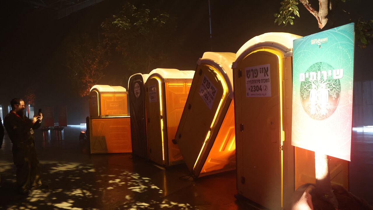 Bullet-riddled toilets that were used by youths who participated in the Supernova festival on October 7, are displayed in a temporary exhibition titled '06:29' in Tel Aviv on December 7, 2023 two months after Palestinian Hamas militants attacked the party-goers, killing scores and taking around 40 hostages back to the Gaza Strip. With empty tents, an abandoned bar and even the original sound system, the new exhibition has recreated the scene of the bloody October 7 Hamas attack on a desert music festival. (Photo by GIL COHEN-MAGEN / AFP)