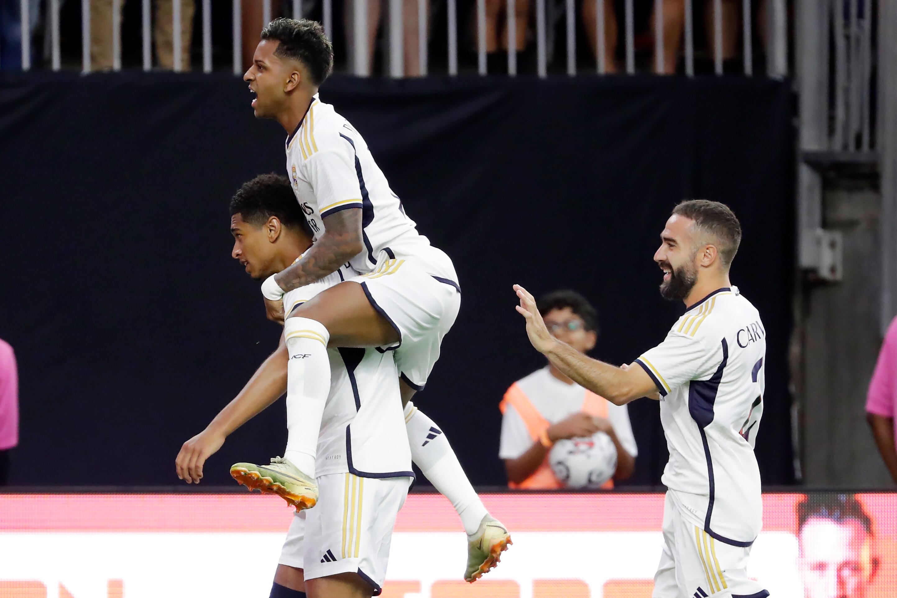 Real Madrid's Jude Bellingham, left, and teammates Rodrygo Silva, center, Daniel Carvajal, right, celebrate the goal by Bellingham during the first half of a Champions Tour friendly soccer match, against Manchester United, Wednesday, July 26, 2023, in Houston. (AP Photo/Michael Wyke)