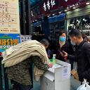 Una mujer china usa una máscara protectora mientras verifica el código de salud en la entrada del mercado local el 26 de enero de 2021 en Wuhan, China. Para frenar la propagación de la enfermedad COVID-19 de la nueva neumonía de la corona, el gobierno chino cerró la ciudad de Wuhan durante 76 días a partir del 23 de enero de 2020. Foto: de Lintao Zhang / Getty Images.