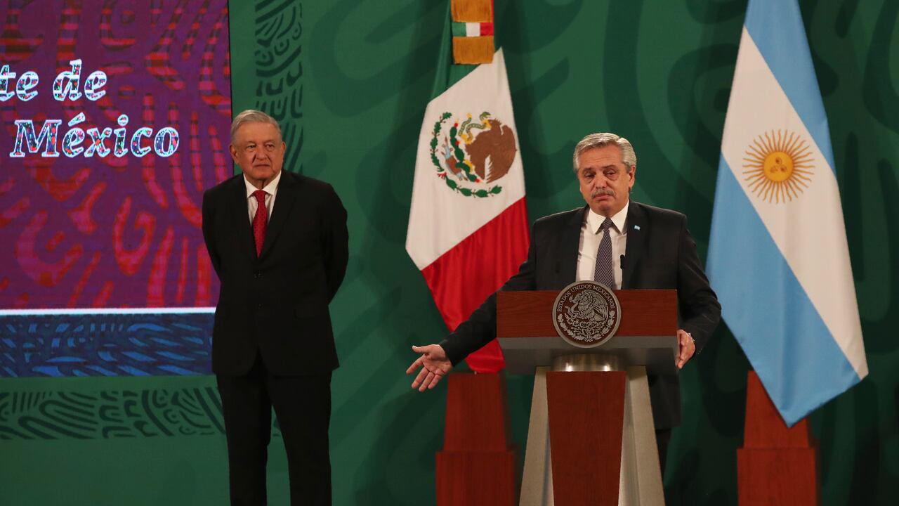 Argentina's President Alberto Fernández speaks during Mexican President Andrés Manuel López Obrador's daily, morning press conference, as Lopez Obrador stands behind at the National Palace in Mexico City, Tuesday, Feb. 23, 2021. Fernández is on a four-day official visit to Mexico. (AP Photo/Marco Ugarte)