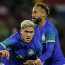 Brazil's Pedro is congratulated by teammate Neymar after scoring his team fifth goal during the international friendly soccer match between Brazil and Tunisia at the Parc des Princes stadium in Paris, France, Tuesday, Sept. 27, 2022. (AP Photo/Christophe Ena)