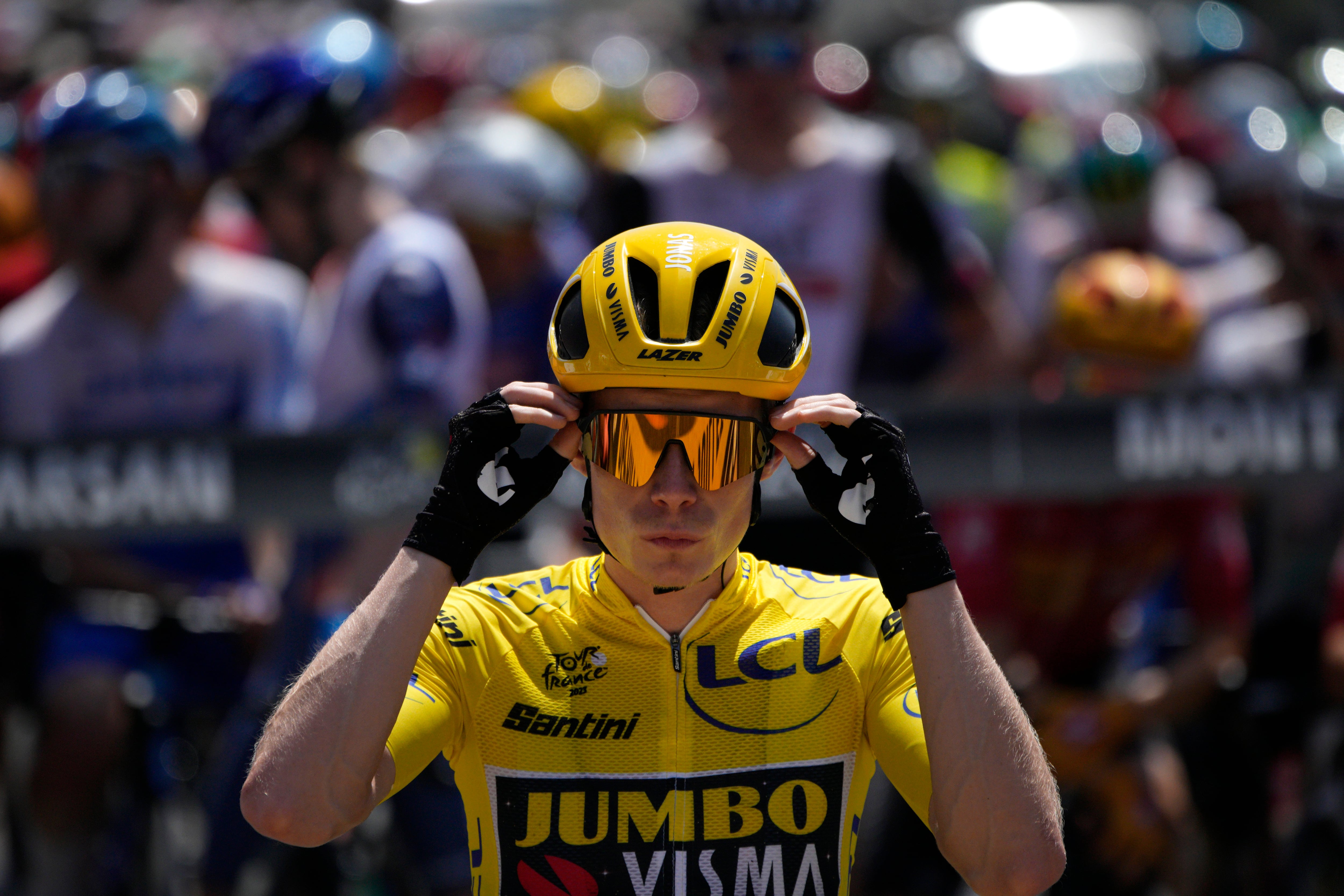 Denmark's Jonas Vingegaard, wearing the overall leader's yellow jersey adjusts his glasses at the start of the seventh stage of the Tour de France cycling race over 170 kilometers (105.5 miles) with start in Mont-de-Marsan and finish in Bordeaux, France, Friday, July 7, 2023. (AP Photo/Daniel Cole)