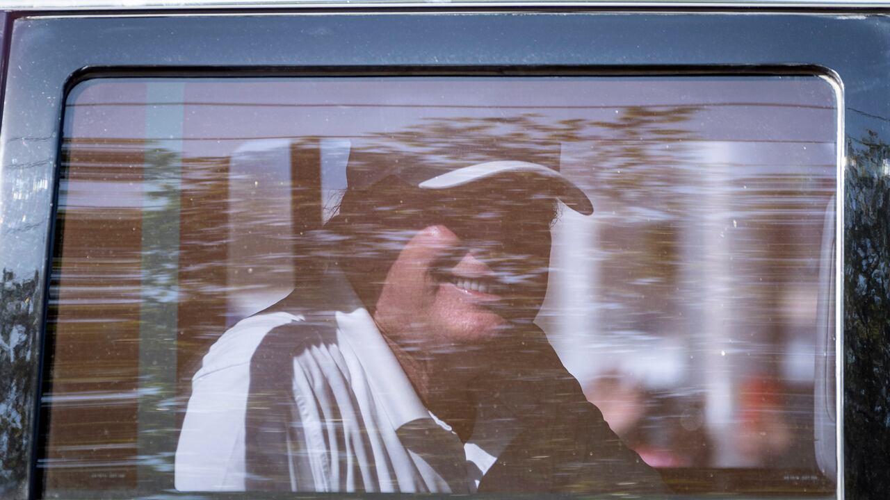 Former President Donald Trump smiles at supporters as he rides by in West Palm Beach, Fla., Monday, Feb. 15, 2021. People lined the street on President's Day to show support for Trump who lost the 2020 election to President Joe Biden. (Greg Lovett/The Palm Beach Post via AP)