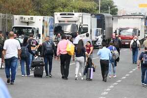 Ciudadanos deciden caminar con sus maletas hasta el aeropuerto, ante el bloqueo de las vías por el paro camionero.