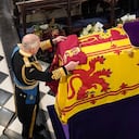 King Charles III places the Queen's Company Camp Colour of the Grenadier Guards on the coffin at the Committal Service for Queen Elizabeth II, held at St George's Chapel in Windsor Castle, Monday Sept. 19, 2022. (Jonathan Brady/Pool Photo via AP)