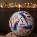 DOHA, QATAR - MARCH 31: In this photo illustration an official FIFA World Cup Qatar 2022 ball sits on display in front of the skyline of Doha ahead of the FIFA World Cup Qatar 2022 draw on March 31, 2022 in Doha, Qatar. (Photo by David Ramos/Getty Images)