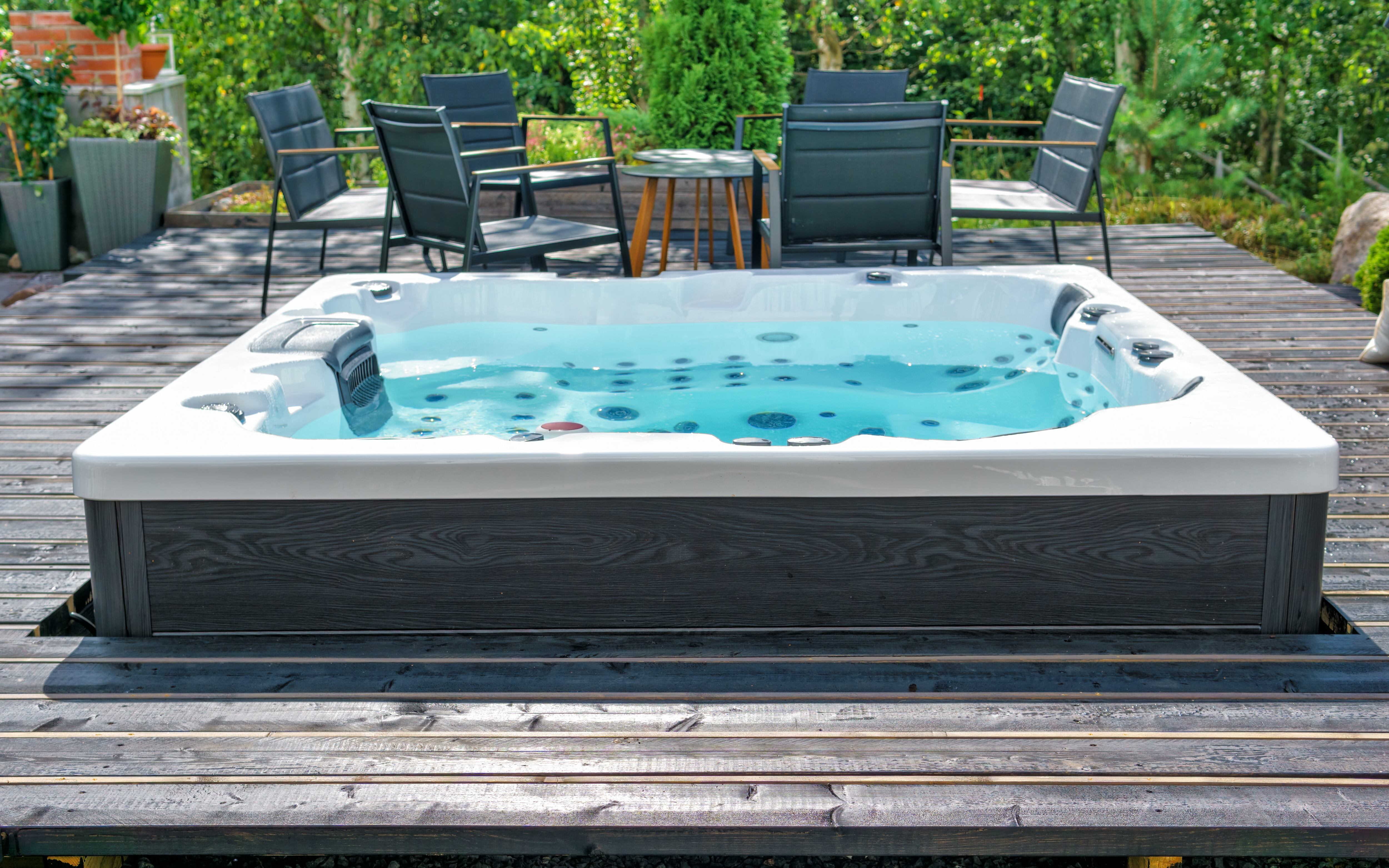 Large hot tub embedded in the backyard terrace