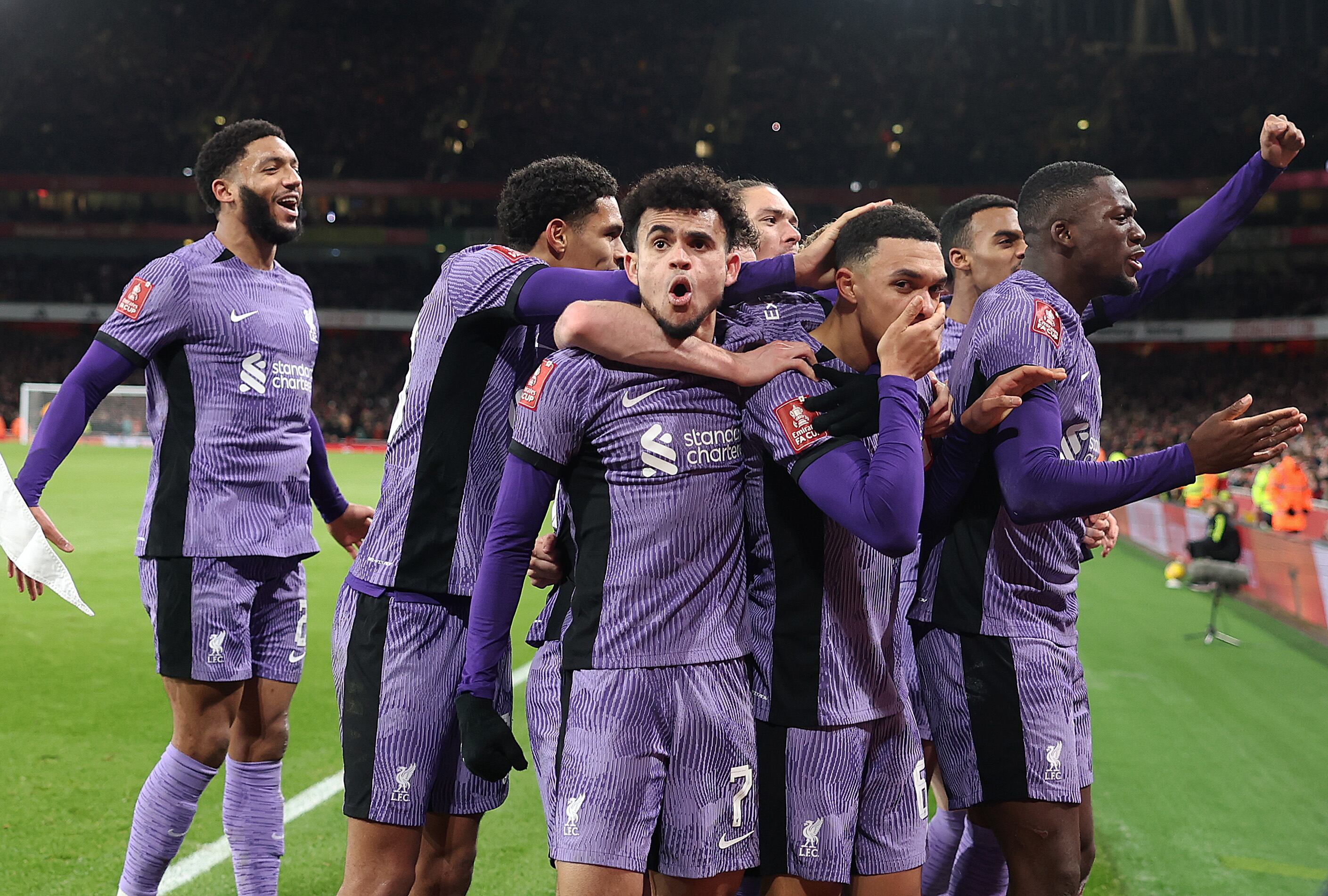 LONDON, ENGLAND - JANUARY 07: Luis Diaz and Trent Alexander-Arnold of Liverpool celebrate with teammates their team's first goal, an own goal scored by Jakub Kiwior of Arsenal during the Emirates FA Cup Third Round match between Arsenal and Liverpool at Emirates Stadium on January 07, 2024 in London, England. Arsenal wear an all-white kit at home, for the first time in the club's history, in support of the 'No More Red' campaign against knife crime and youth violence. (Photo by Julian Finney/Getty Images)