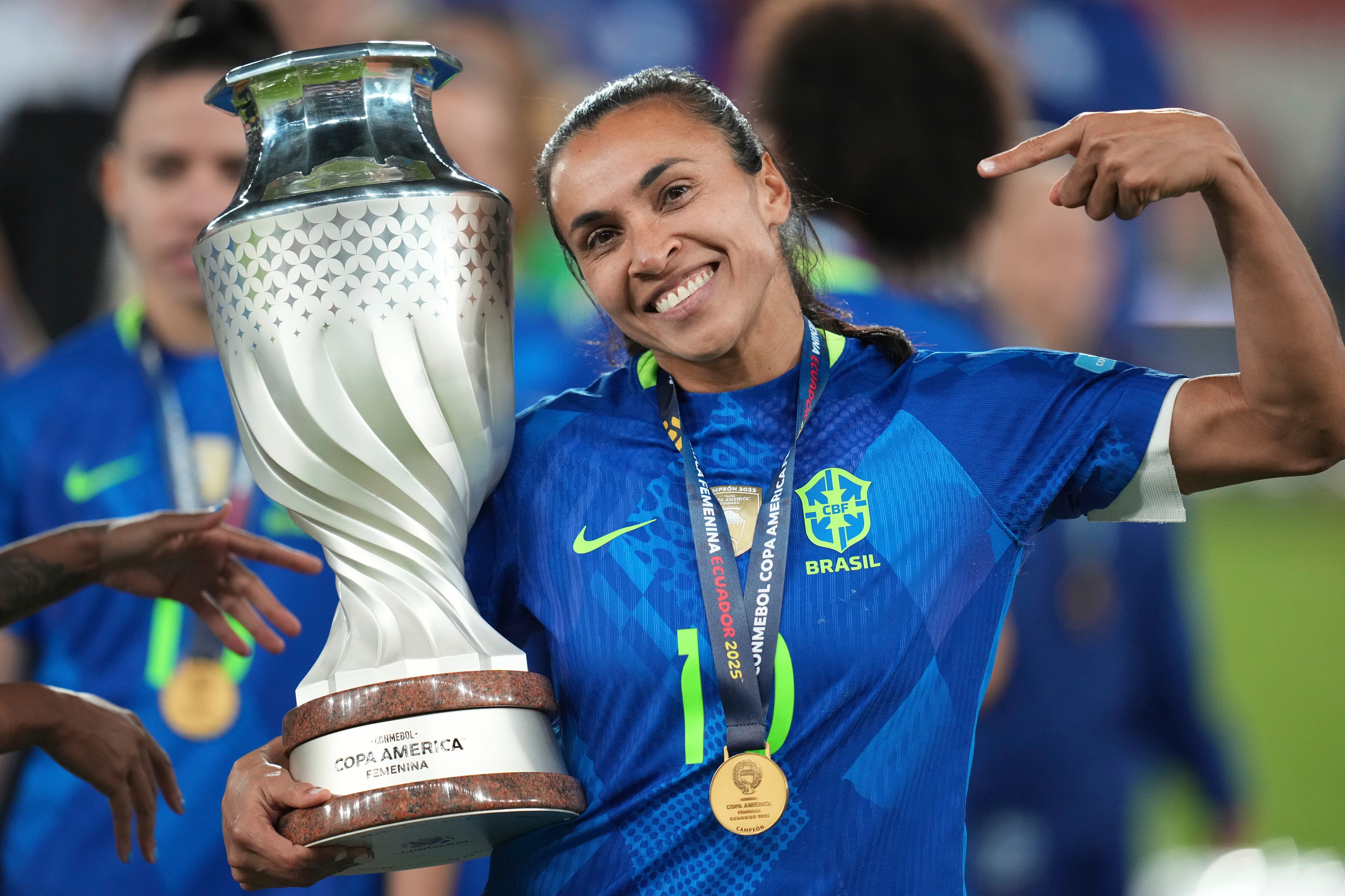 Brazil's Marta holds the trophy after winning the Women's Copa America final soccer match against Colombia in a penalty shootout at Rodrigo Paz Delgado stadium in Quito, Ecuador, Saturday, (AP Photo/Dolores Ochoa)